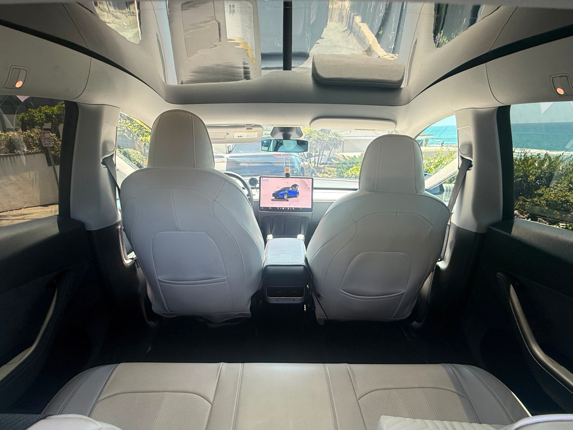 White leather Tesla interior with panoramic glass roof