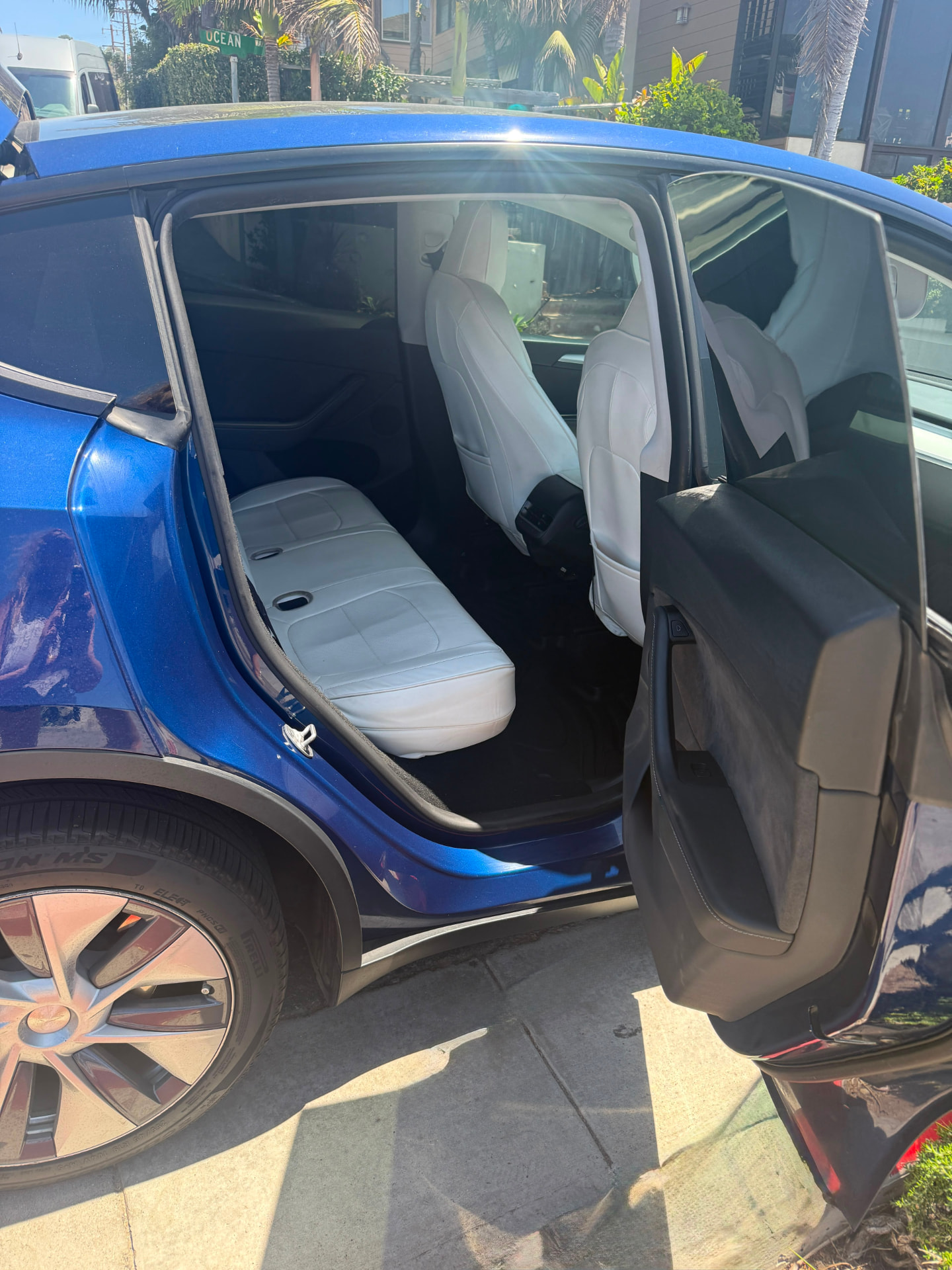 Rear door open showing the white leather cabin